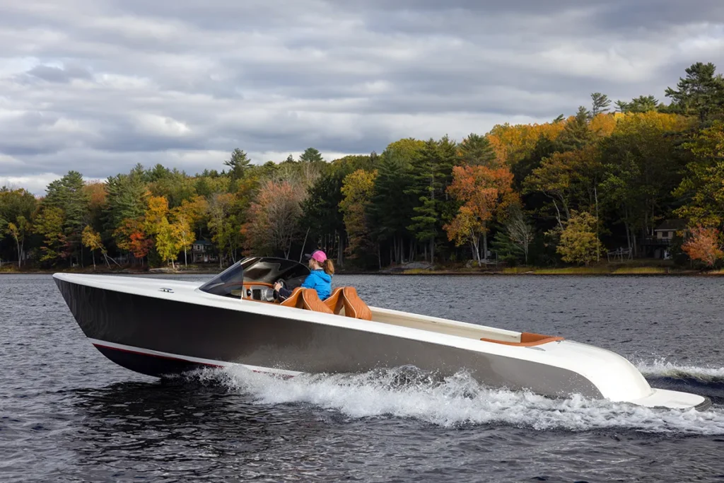ISOBEL being driven on a lake by a woman